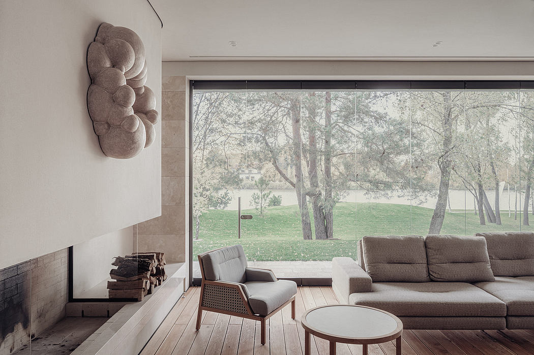 Large windows offer a scenic outdoor view, complementing the cozy, modern furnishings.