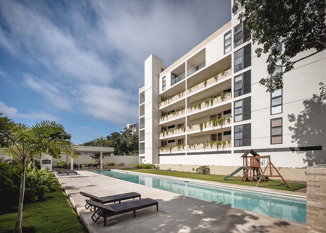 Contemporary apartment building with poolside loungers and a play area.