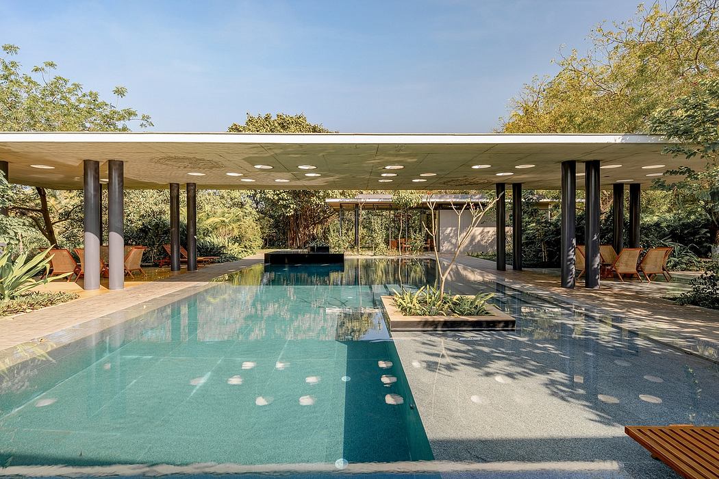 Sleek, modern pool area with lush greenery, reflecting pool, and architectural details.