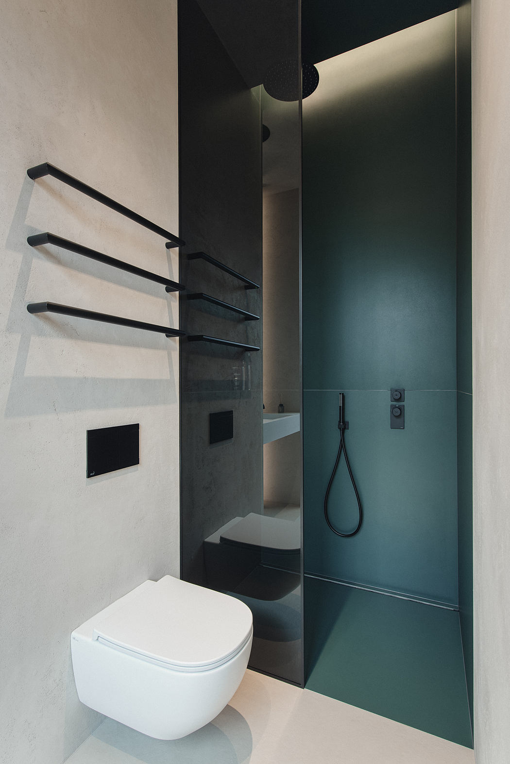 A minimalist bathroom with a black and white color scheme, wall-mounted shelves, and a sleek shower enclosure.