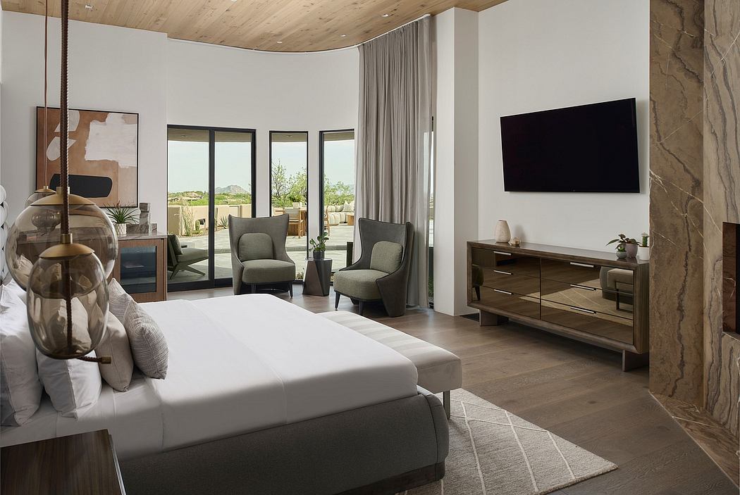 Spacious modern bedroom with wood paneled ceiling, plush furnishings, and panoramic views.