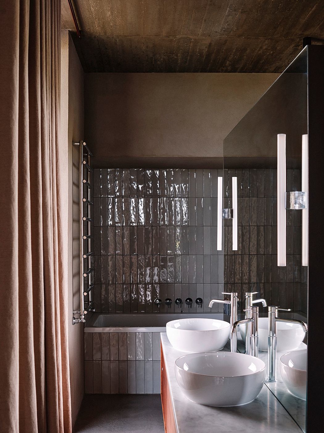 Modern bathroom with twin basins, tiled wall, and large mirror.