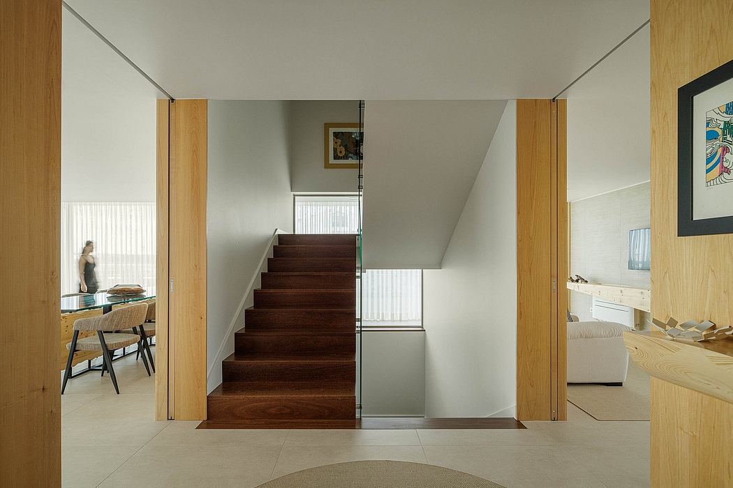 Minimalist interior design with wooden stairs, neutral tones, and open floor plan.