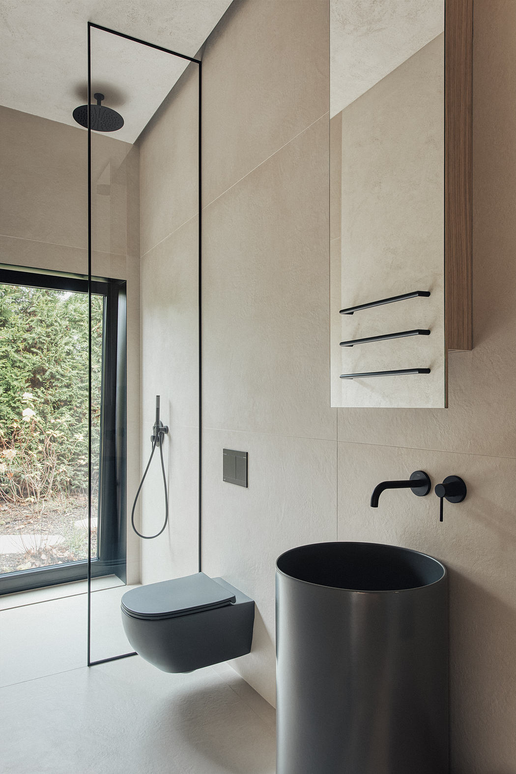 Modern minimalist bathroom with sleek black fixtures, freestanding basin, and large glass window.