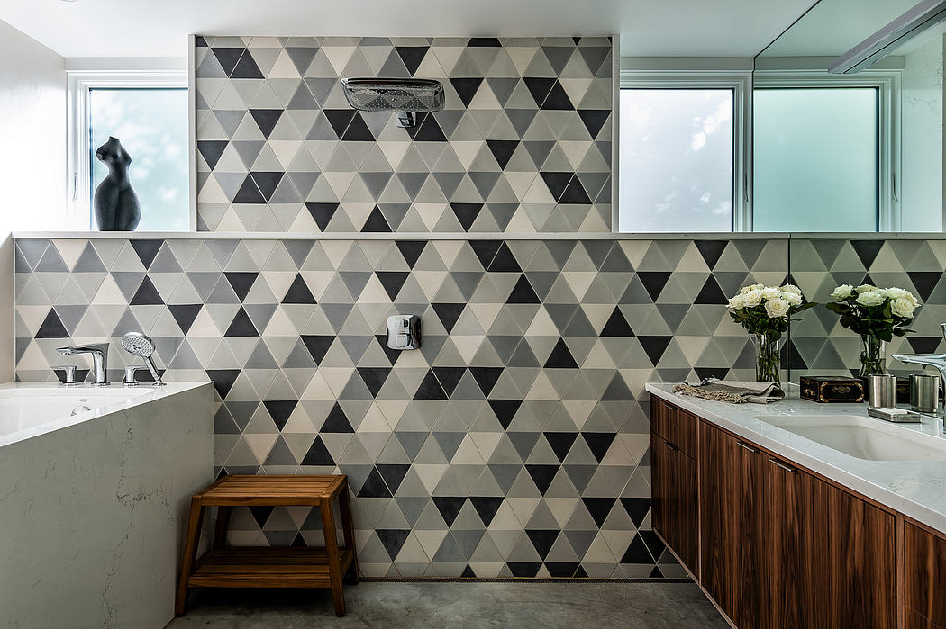 Striking geometric tile pattern adorns modern bathroom walls. Sleek, minimalist design.