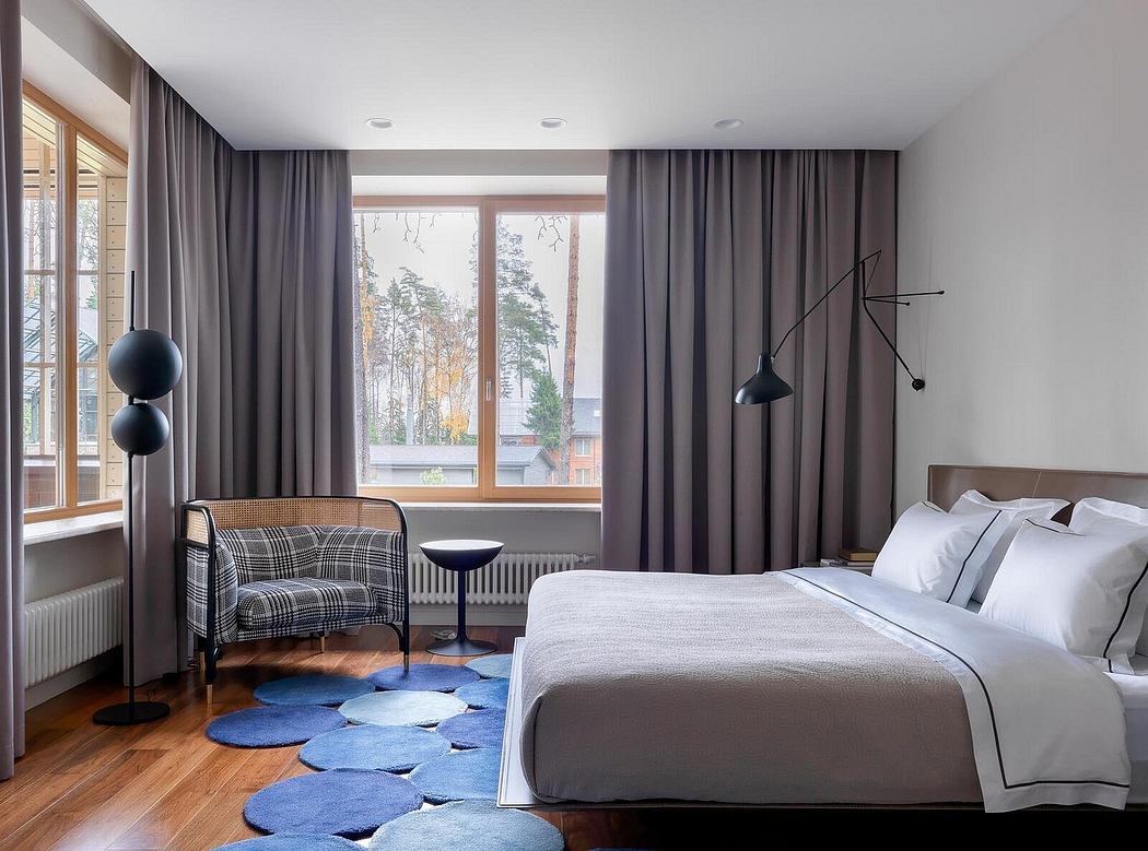 A luxurious bedroom with large windows, dark curtains, and contemporary furnishings.