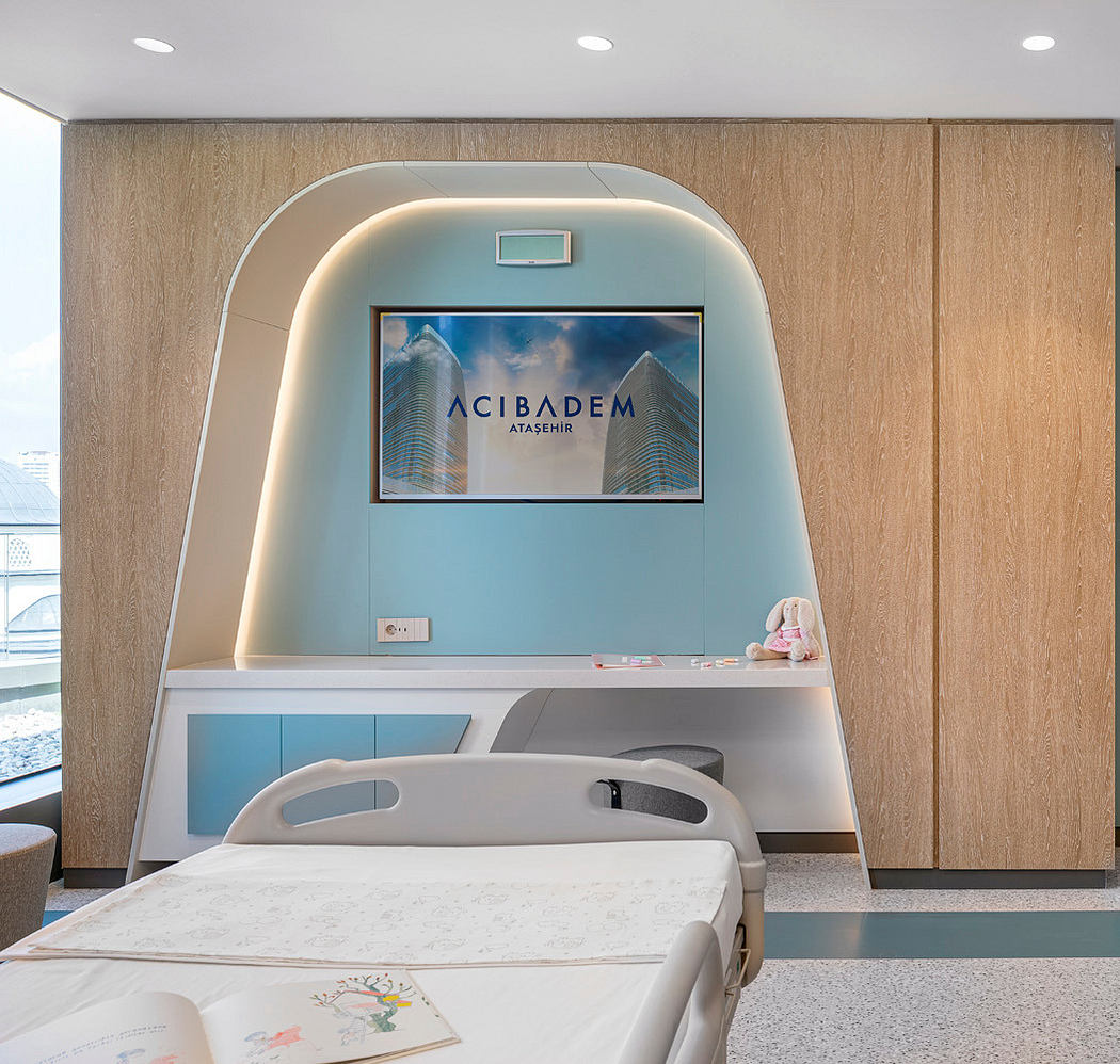 Contemporary hospital room with sleek wood panels and an arch feature above bed.