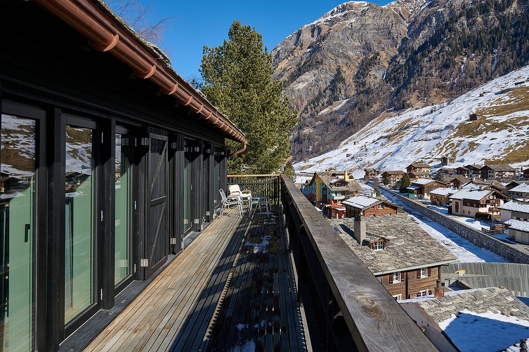Alpine chalet balcony with mountain view.
