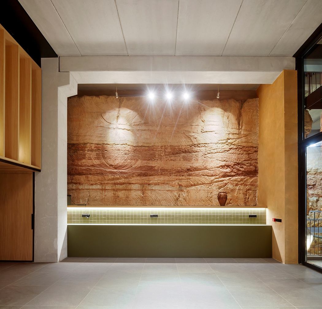 Contemporary interior with textured stone wall and pendant lights.