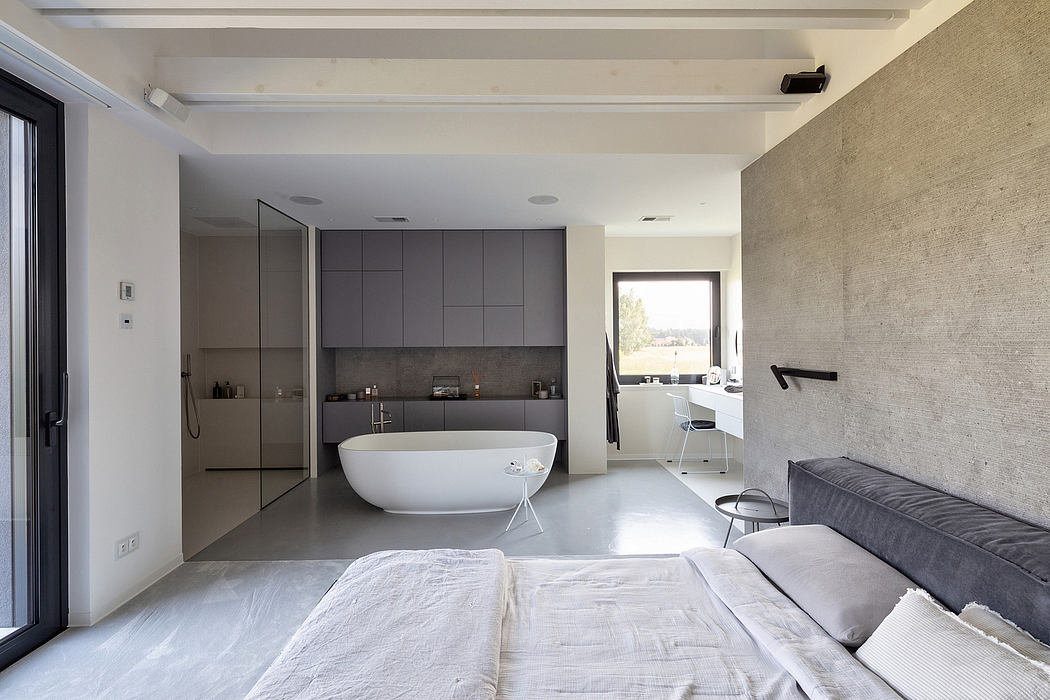 Minimalist bedroom with an open-plan ensuite bathroom.