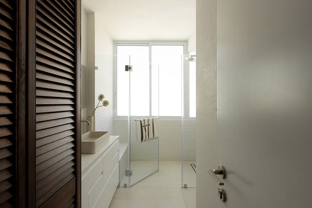 Sleek bathroom with glass shower and white vanity.