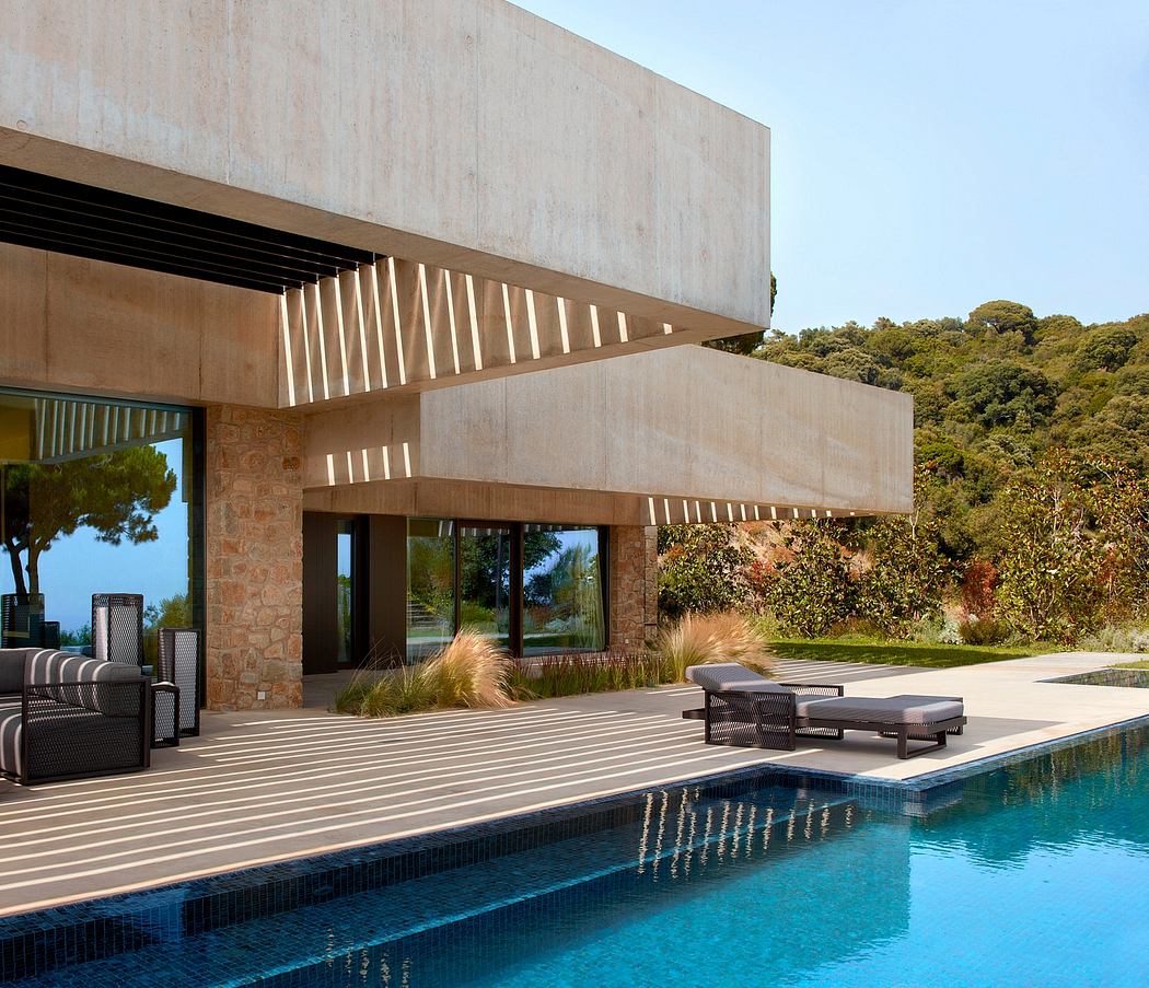 Modern house with poolside loungers and cantilevered upper level.