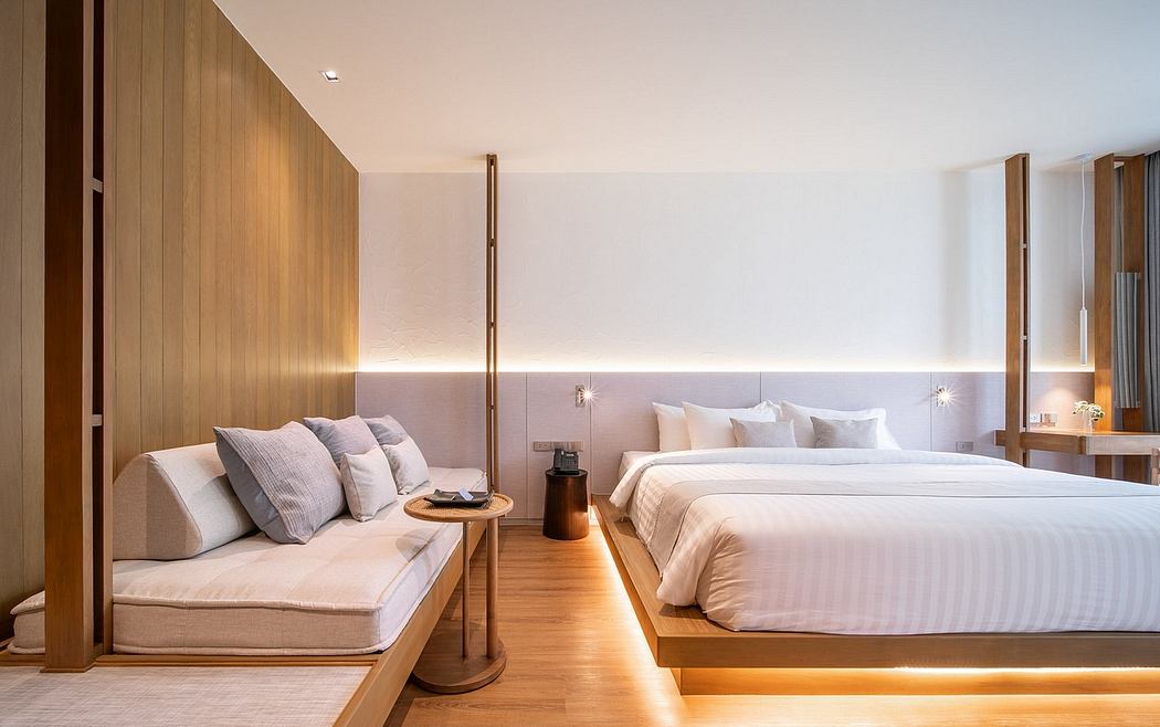 Modern bedroom with two beds, wooden furniture, and soft lighting.