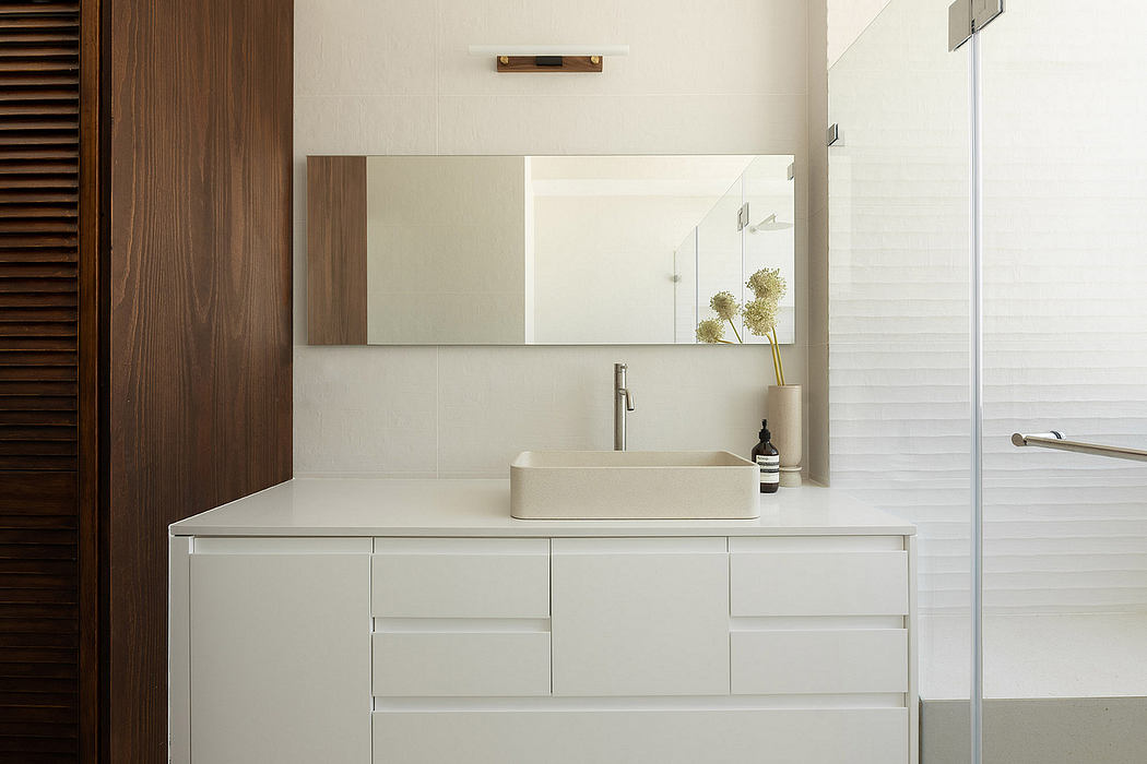 Sleek bathroom vanity with minimalist design and mirror.