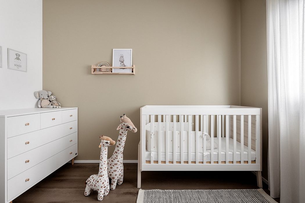Simple and elegant nursery with white furniture and neutral tones.