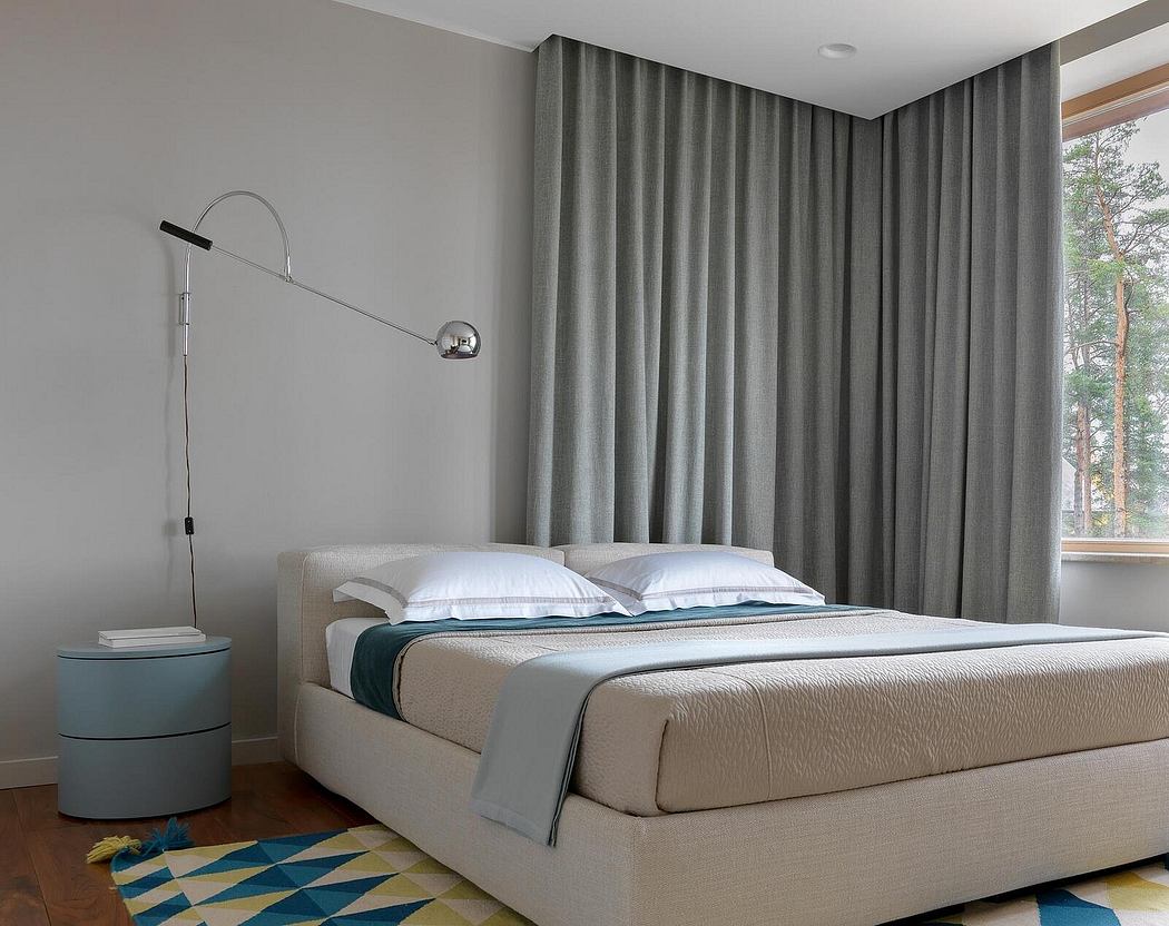 Minimalist bedroom with gray curtains, modern floor lamp, and patterned area rug.