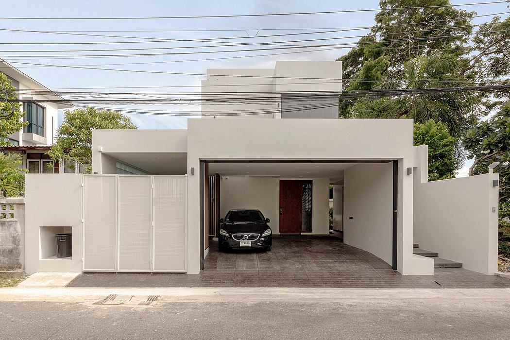 Contemporary house with geometric design and carport.