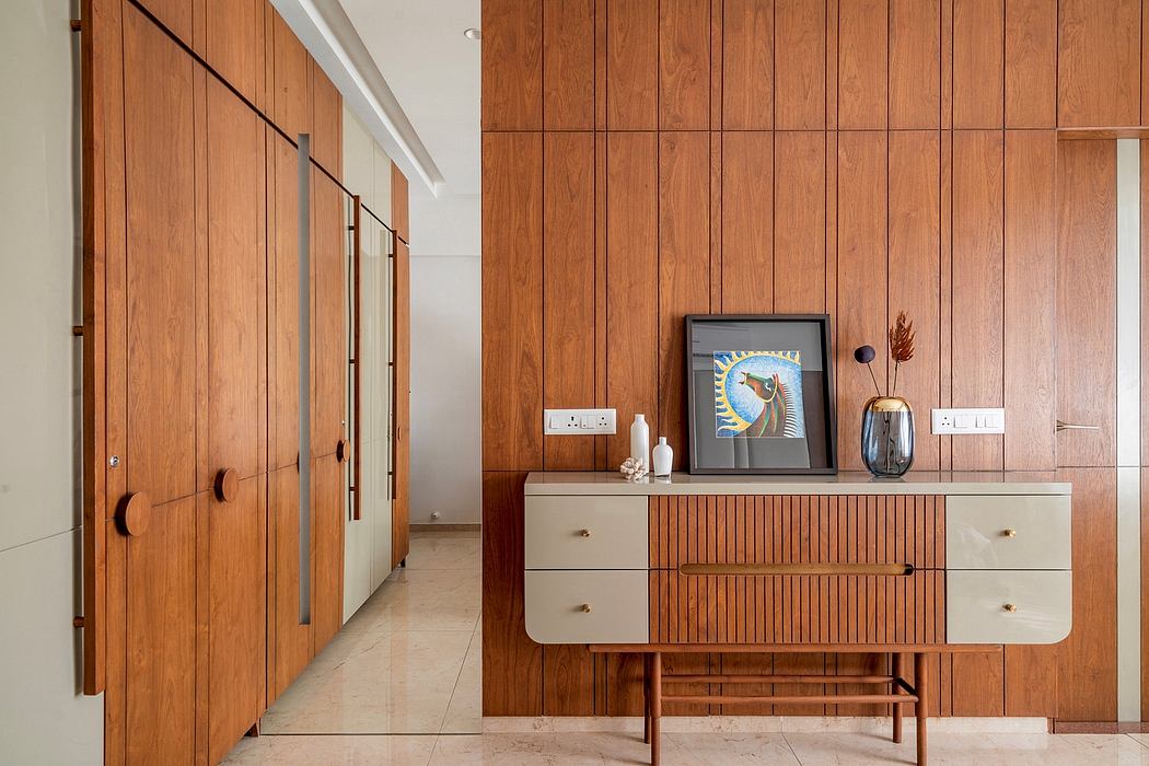 Modern hallway with wooden paneling and a sideboard with decorative items.