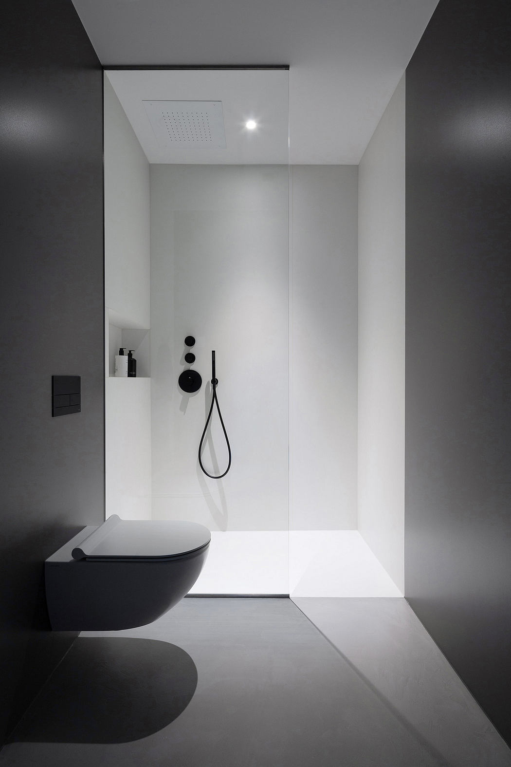 Modern minimalist bathroom with monochromatic tones and sleek fixtures.