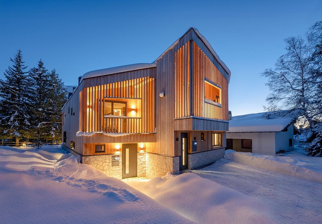Rustic wooden chateau with stone accents and warm lighting against snowy backdrop.