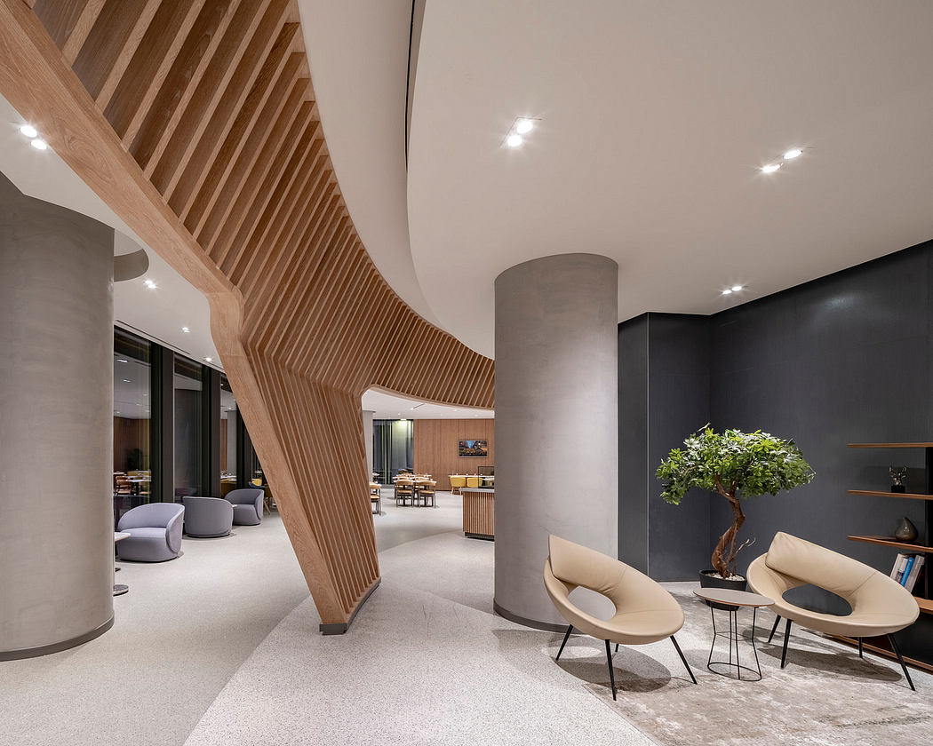 Modern interior with curved wooden staircase, concrete pillars, and elegant furniture.