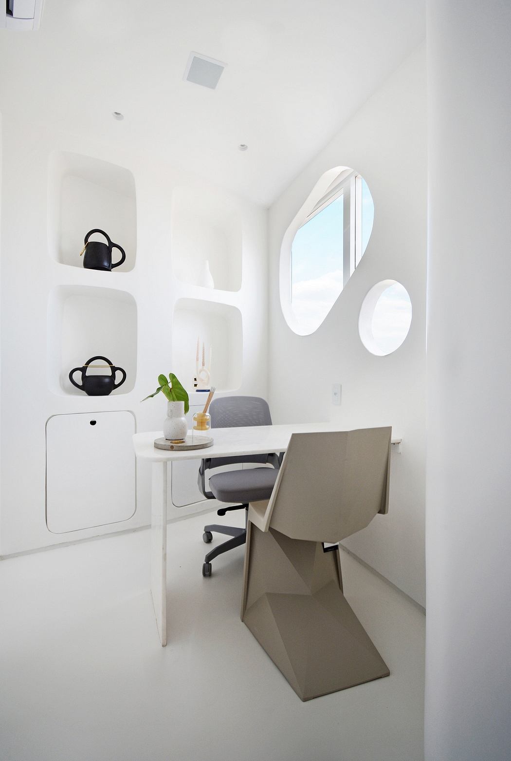 A minimalist, contemporary office space with clean lines, muted colors, and unique furnishings.