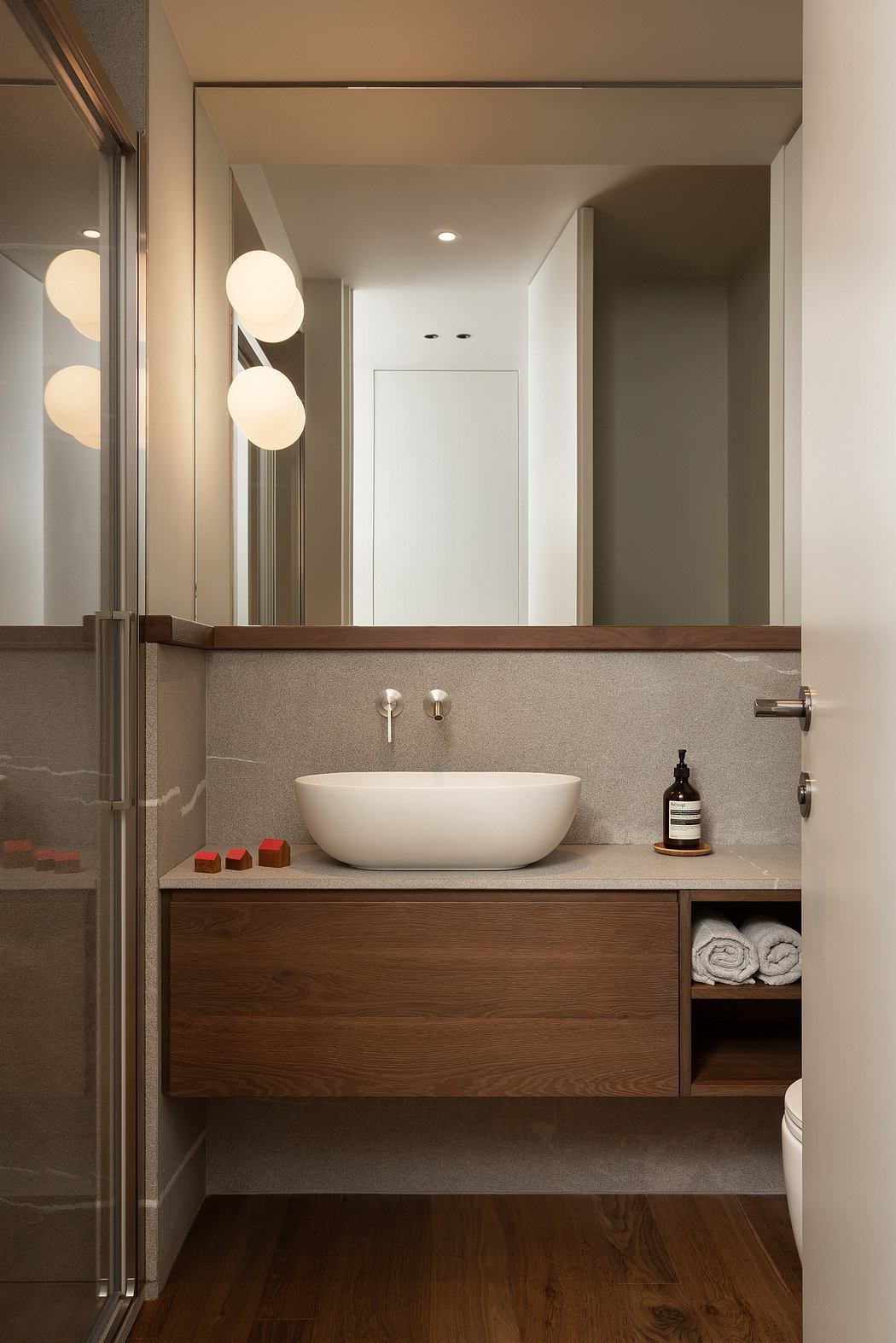 Modern bathroom interior with wooden vanity and vessel sink.