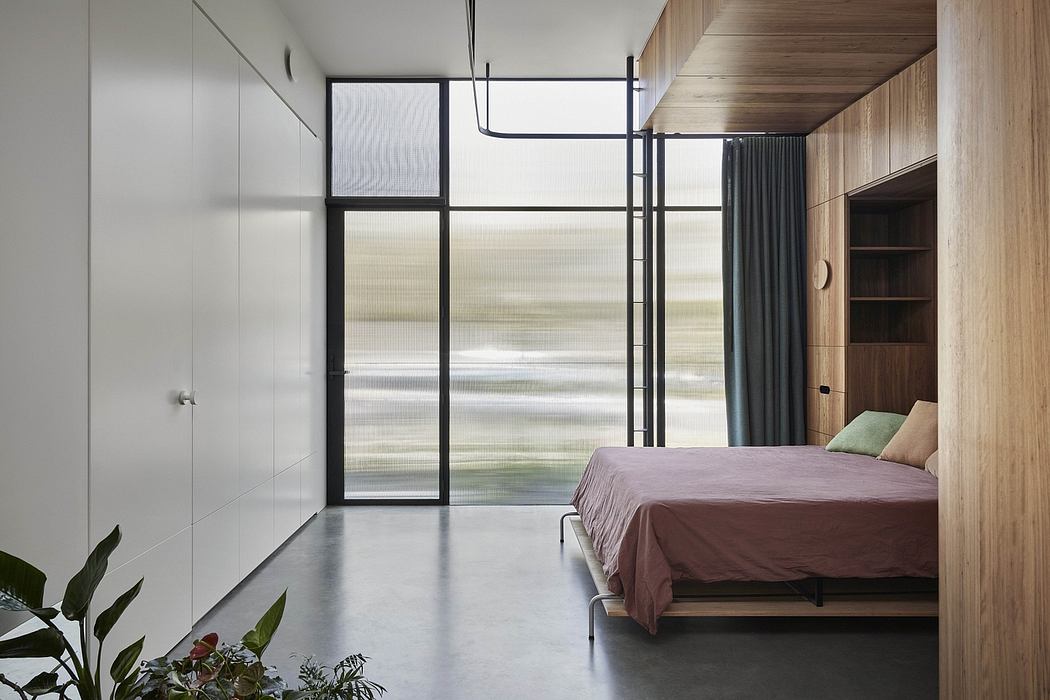 Minimalist bedroom with floor-to-ceiling windows, wood accents, and built-in shelving.