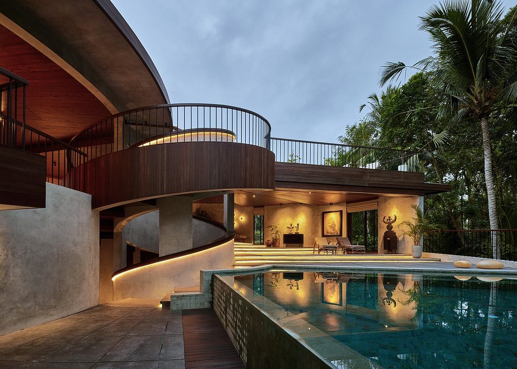 Curved wooden architecture with illuminated outdoor pool and lush greenery.