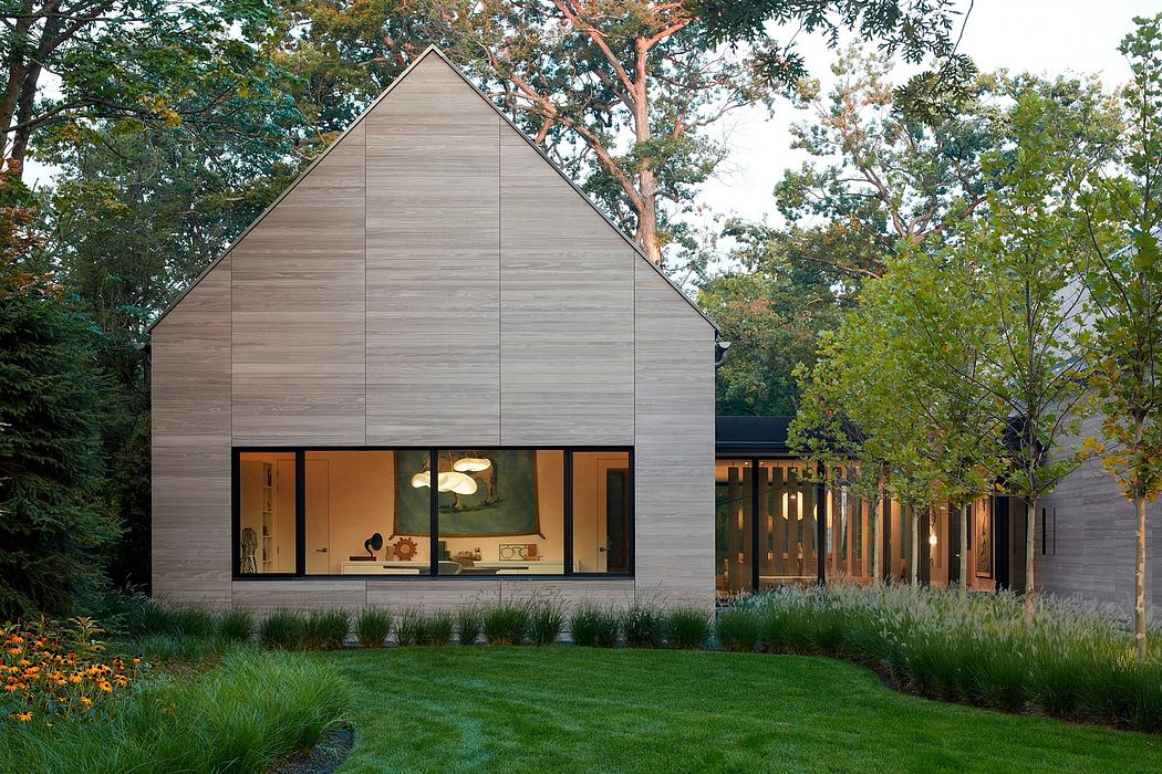Contemporary house with large windows surrounded by trees
