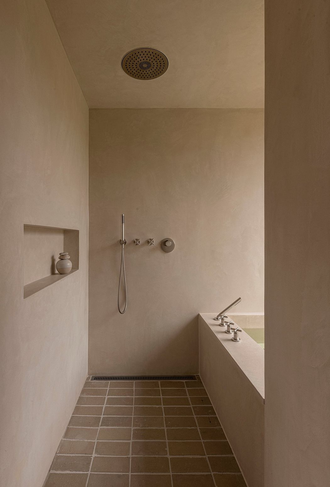 Minimalist bathroom with beige walls and built-in tub.