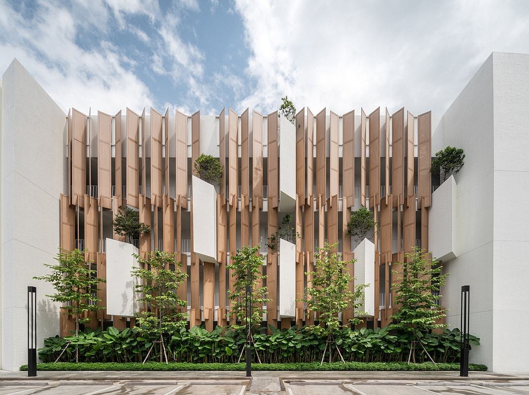 Modern building facade with vertical wooden fins and integrated greenery.