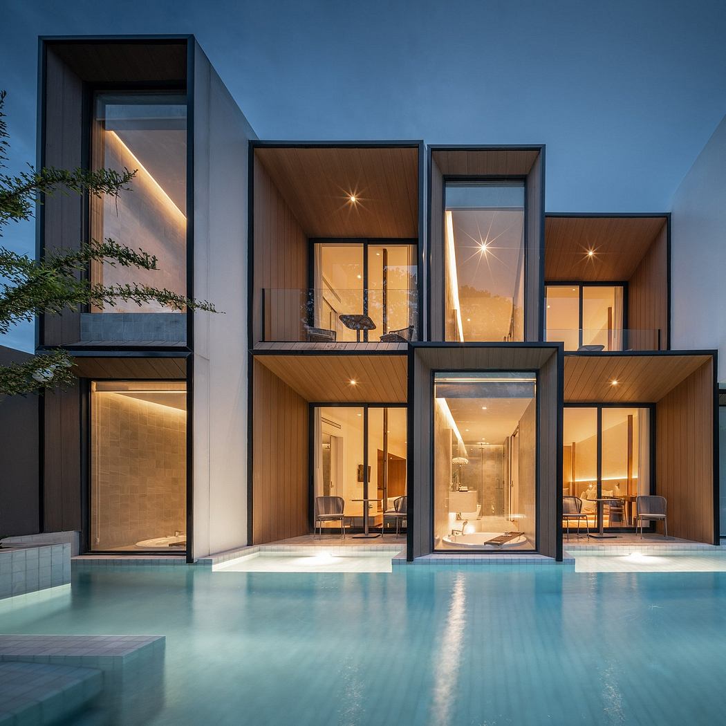 Modern house facade at dusk with illuminated interiors and pool.
