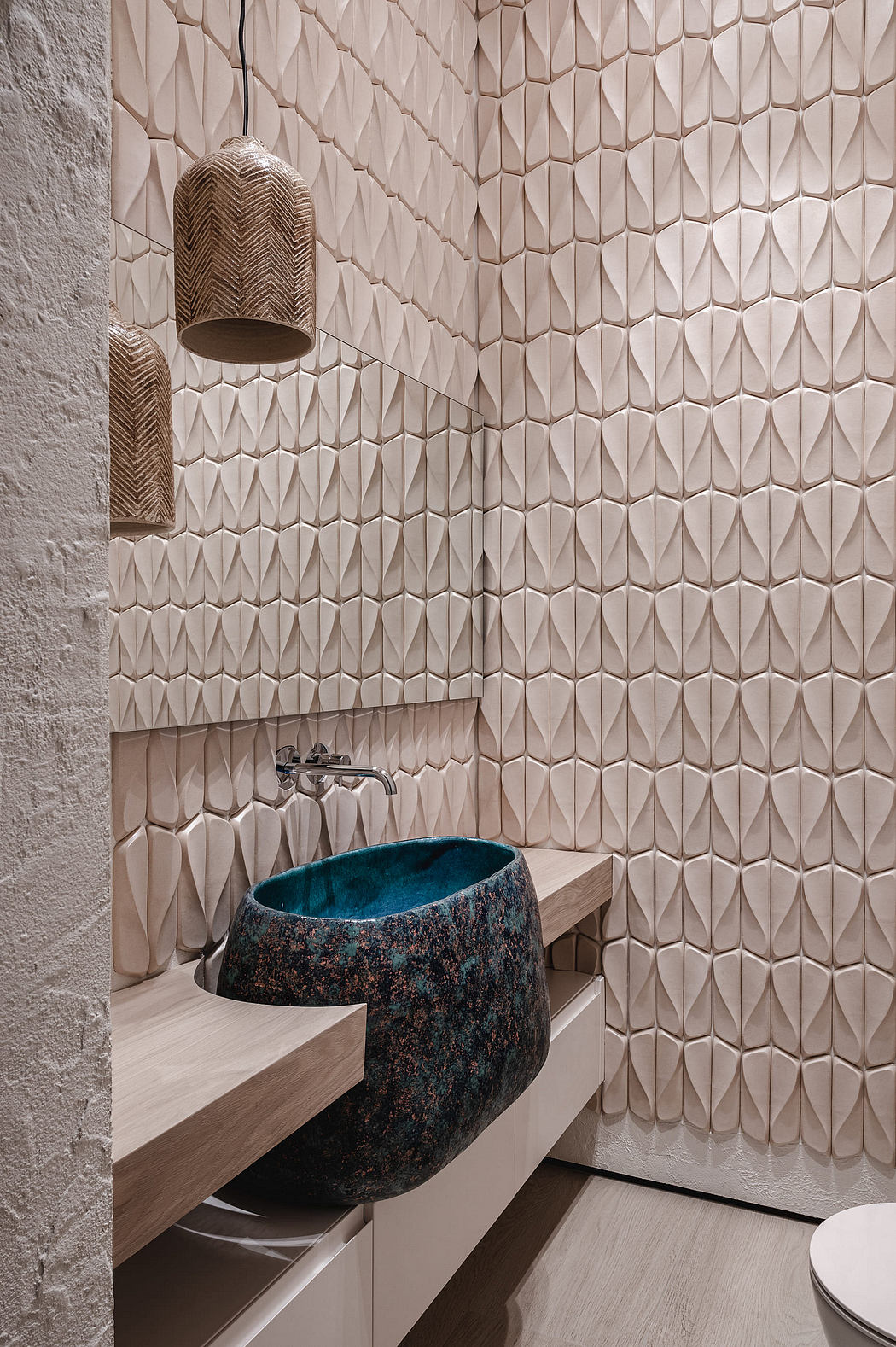 Intricate tile pattern adorns bathroom walls, complementing the striking ceramic basin.