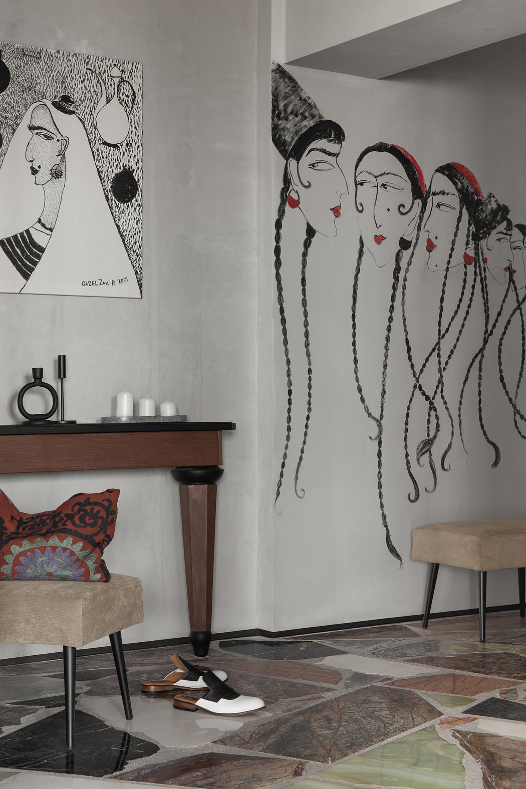 A modern interior featuring abstract wall art, wooden furniture, and a tiled floor.