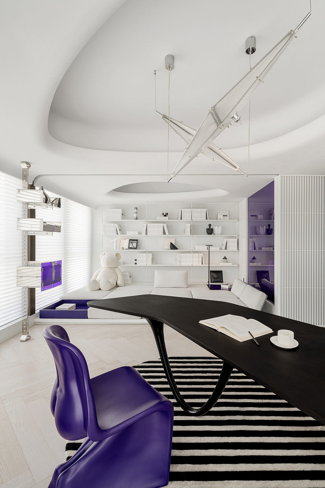 A modern home office with minimalist furniture, geometric lighting, and a striking color palette.
