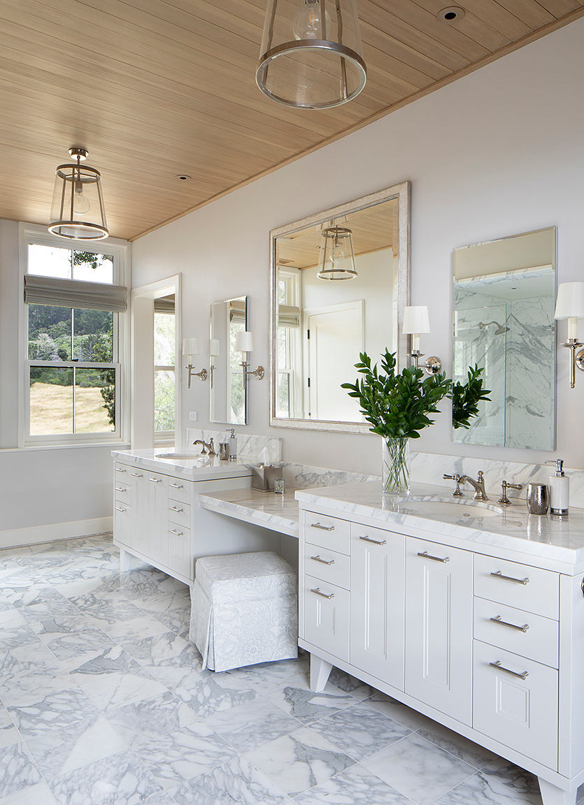 Spacious bathroom with marble floors, double vanity, and ample natural light.