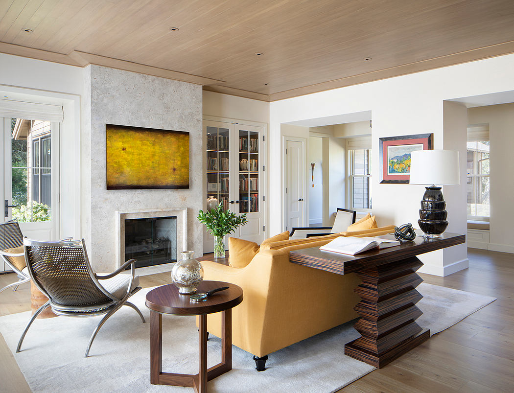 A modern, open-concept living room with wooden ceiling, fireplace, and eclectic furniture.