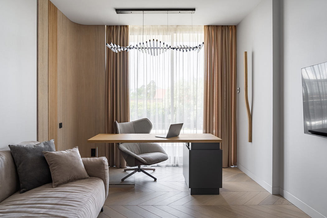 Elegant modern home office with sleek furniture, lighting fixture, and wood-paneled walls.