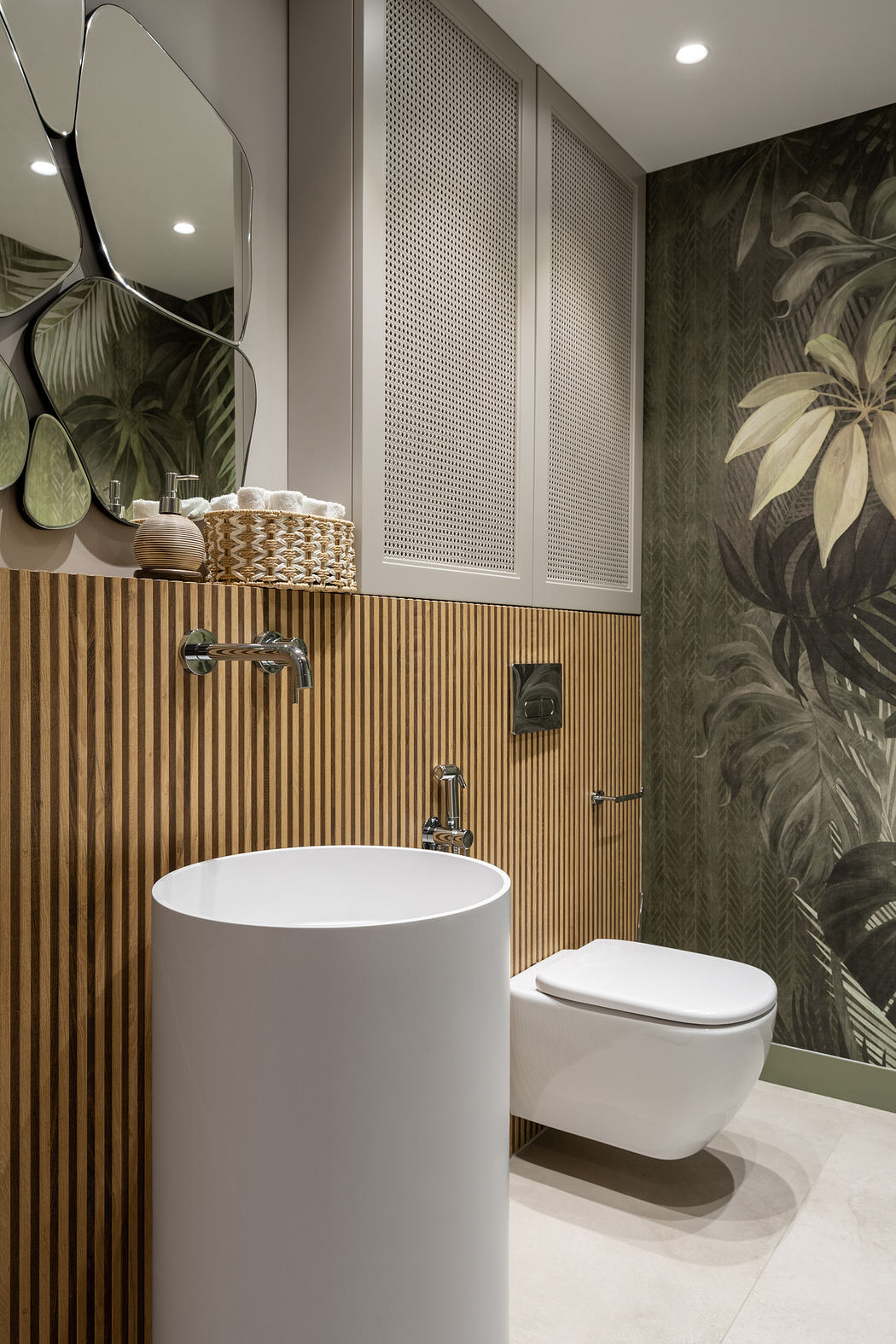 Elegant bathroom with sleek vessel sink, wood paneling, and tropical-themed wallpaper.