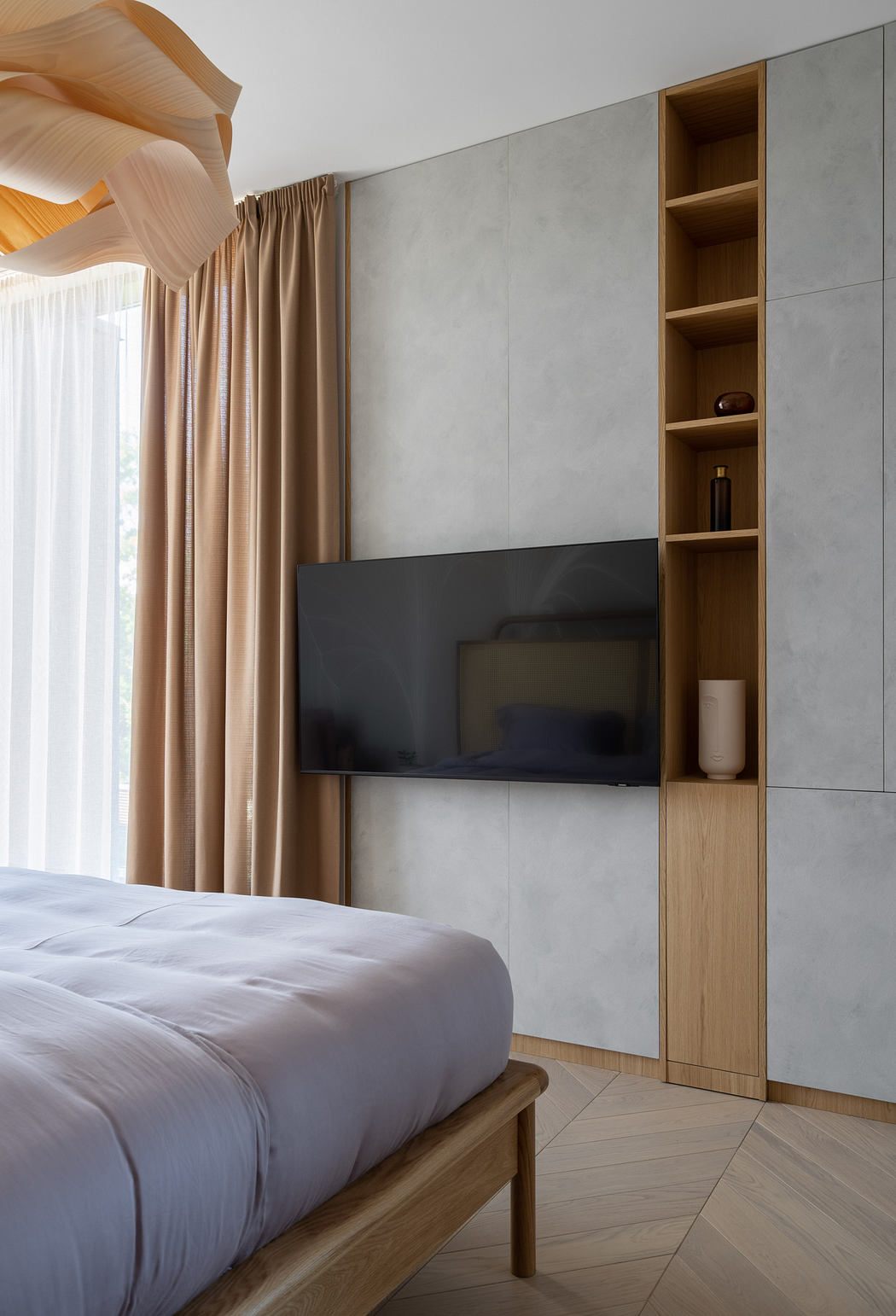 Minimalist bedroom interior with gray walls, wooden shelving, and a mounted TV.