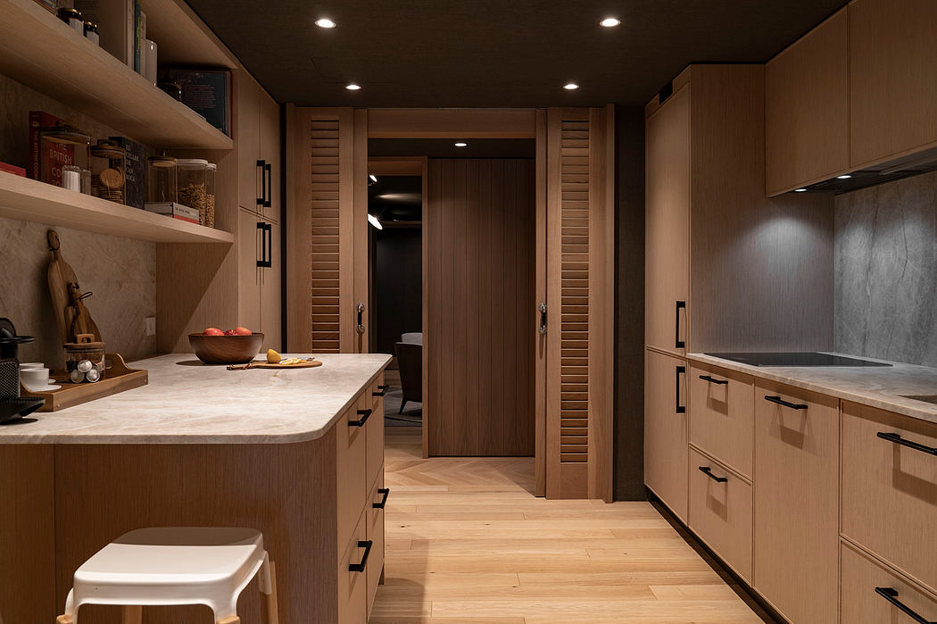 A modern, wood-paneled kitchen with sleek cabinets, countertops, and recessed lighting.