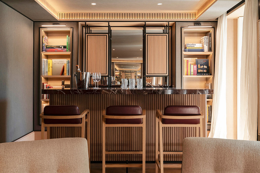 Sleek, modern bar area with wooden paneling, display shelves, and leather barstools.