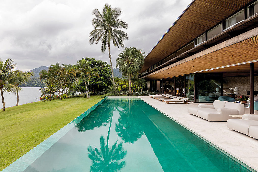 Expansive villa with sleek architectural design and lush tropical surroundings.