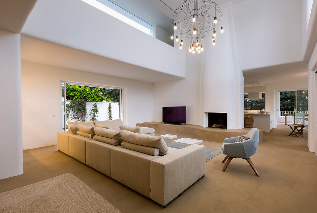 Spacious open-concept living room with modern furnishings, high ceilings, and geometric lighting fixture.