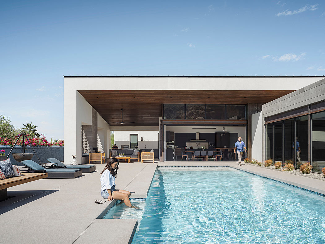 Sleek, modern home with an inviting pool area, wooden beams, and large windows.
