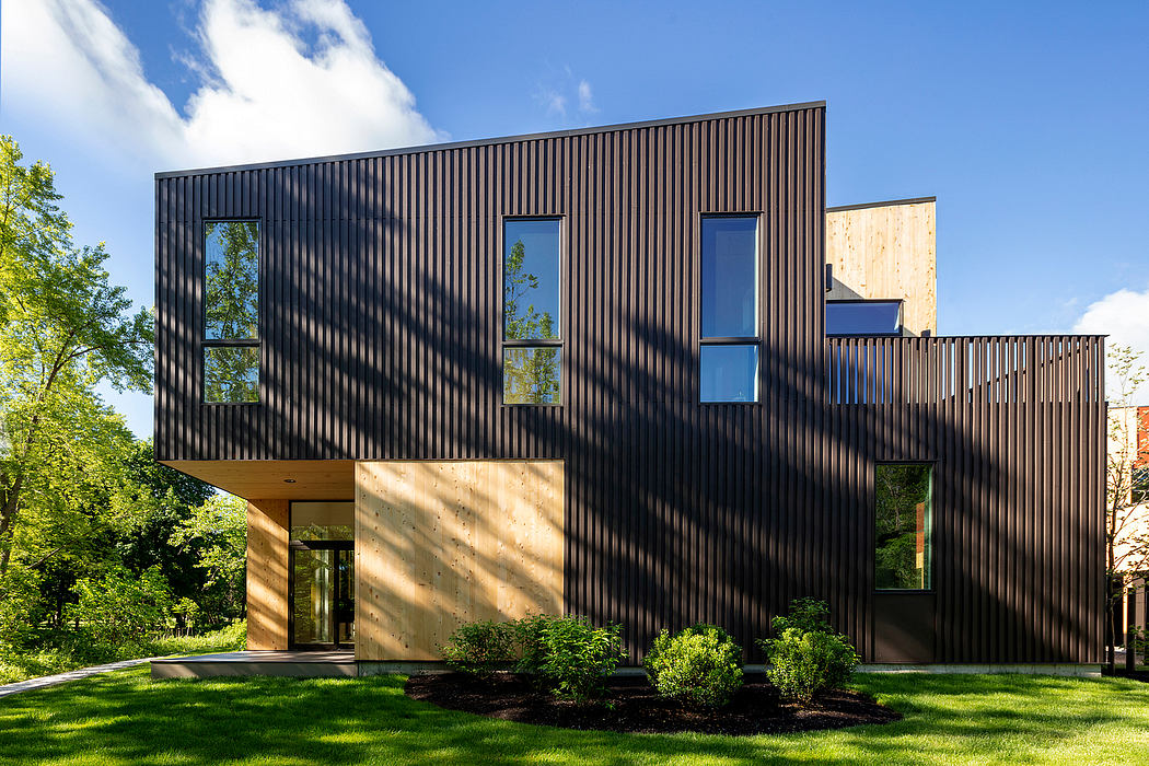A striking modern home with a sleek, vertically-lined facade and large windows.