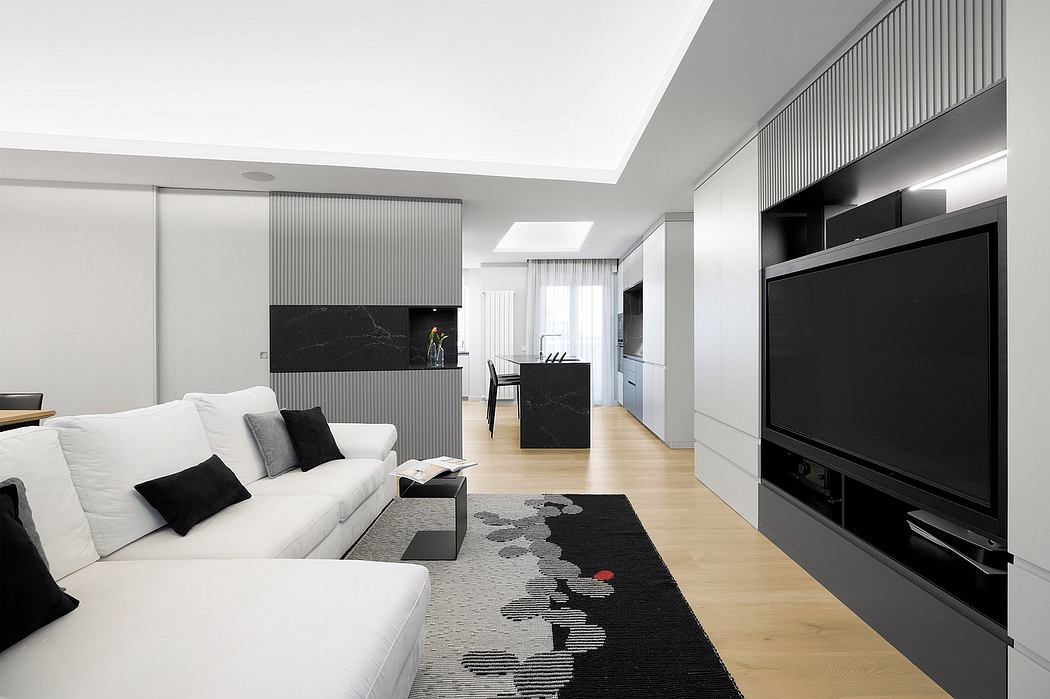 Modern living room with clean lines, sleek black accents, and wood flooring.