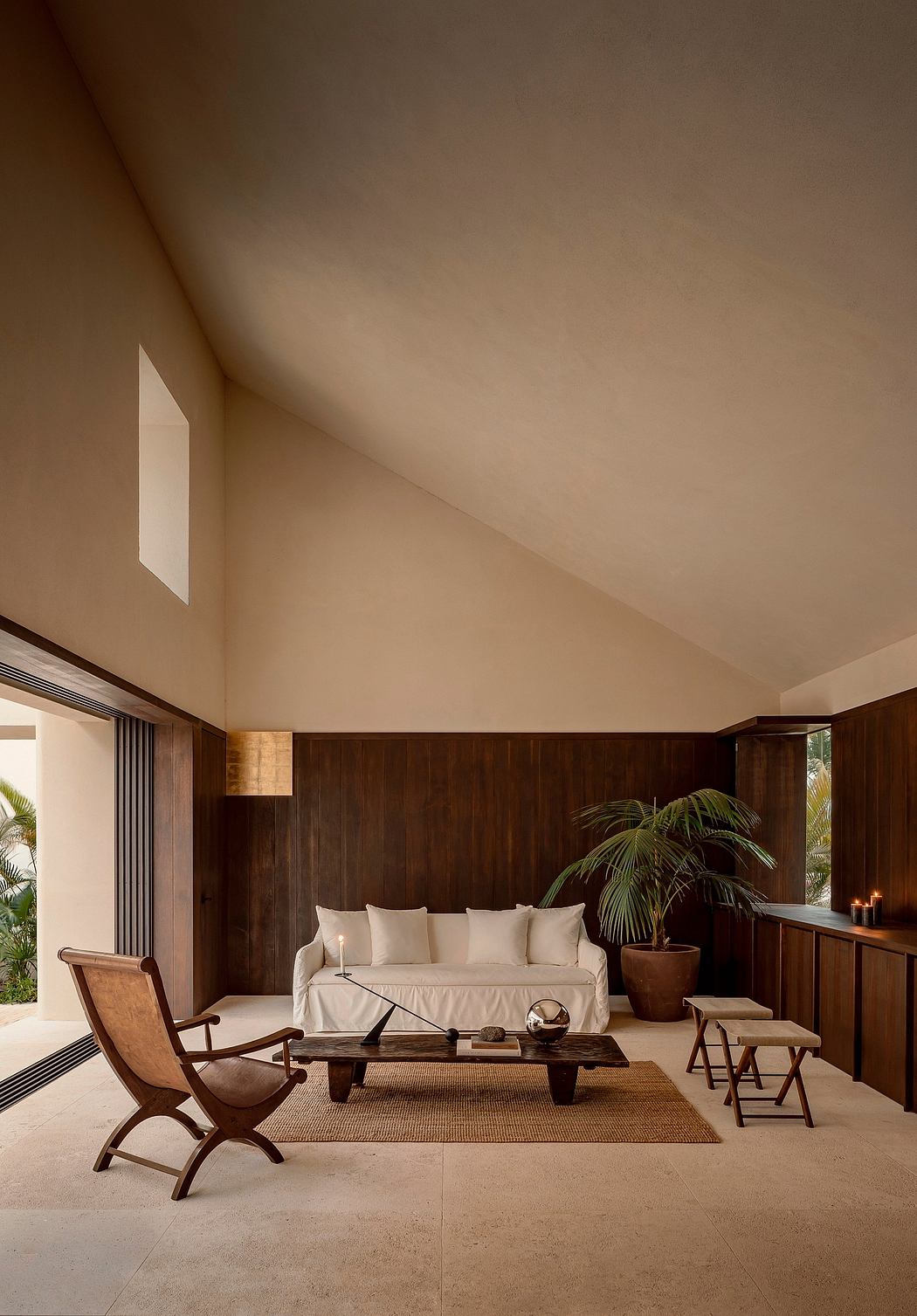 A cozy living room with wooden walls, plush seating, and a minimalist coffee table. Warm, inviting atmosphere.