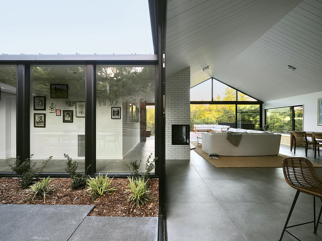 A modern, open-concept home with expansive windows, allowing natural light to flood the interior.